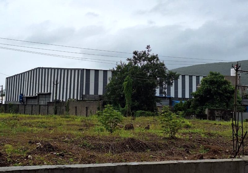 The Biogreen Energy plant seen across open farmland near Junagadh