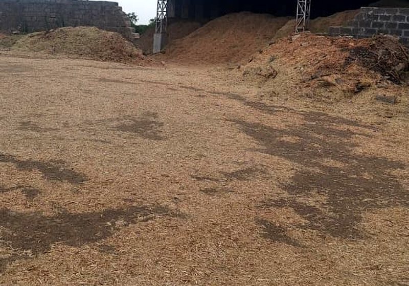 Stockpiles of groundnut shell and agro residue held at the plant