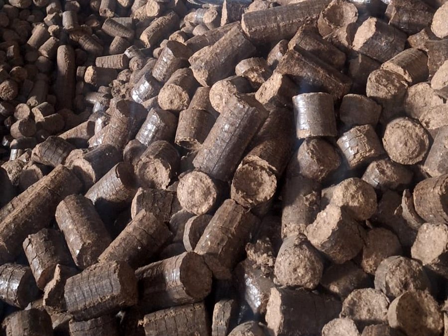 Pile of round 90 mm biomass briquettes pressed from groundnut shell